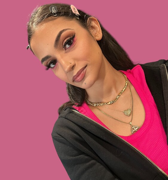 Soft nude makeup with a playful pop of pink on the eyes