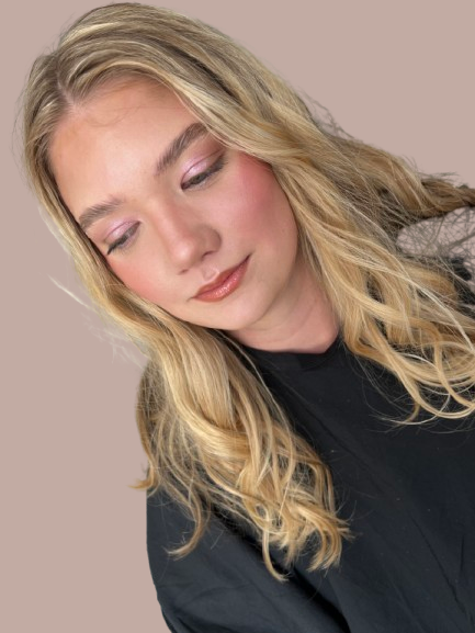 A delicate pink-blushed prom look featuring soft shimmer and effortless glow